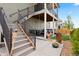 Outdoor living space featuring a porch swing, black metal railings, and stairs leading to the upper level at 15020 Cast Pebble Cir, Parker, CO 80134
