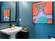 Stylish powder room featuring modern fixtures, a unique sink, and artistic wall decor at 15020 Cast Pebble Cir, Parker, CO 80134