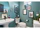 Stylish powder room with a pedestal sink, modern fixtures, and decorative wall art at 15020 Cast Pebble Cir, Parker, CO 80134