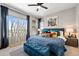 Bright bedroom featuring stylish décor, ample natural light and a decorative screen in front of the window at 15020 Cast Pebble Cir, Parker, CO 80134