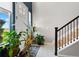 Inviting entryway features tiled floors, decorative plants, and a staircase leading to the upper level at 15020 Cast Pebble Cir, Parker, CO 80134