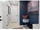 Entryway showcasing stylish tile flooring, a dark accent wall, a bench and a large painting at 15020 Cast Pebble Cir, Parker, CO 80134