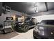 Finished garage with two cars, a treadmill, a workbench and custom storage solutions at 15020 Cast Pebble Cir, Parker, CO 80134