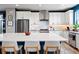 Modern kitchen with white cabinets, stainless steel appliances, and a spacious island with seating at 15020 Cast Pebble Cir, Parker, CO 80134