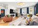 Elegant living room features a large sofa, fireplace, hardwood floors, and stylish accent pieces at 15020 Cast Pebble Cir, Parker, CO 80134