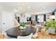 Bright, open living space with a dining area, staircase, and cozy seating arrangements at 15020 Cast Pebble Cir, Parker, CO 80134
