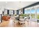Open living space with dining area, cozy seating, and a view to an outdoor balcony at 15020 Cast Pebble Cir, Parker, CO 80134