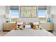 Serene main bedroom featuring a well-made bed, symmetrical nightstands, stylish decor, and tranquil views at 15020 Cast Pebble Cir, Parker, CO 80134