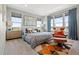Bright main bedroom with large windows offering scenic views, stylish furniture, and patterned rug at 15020 Cast Pebble Cir, Parker, CO 80134