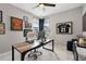 Well-lit home office featuring a modern desk, comfortable chair, artwork, and views through the window at 15020 Cast Pebble Cir, Parker, CO 80134