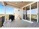 Spacious outdoor patio with gas grill, seating, and sliding glass doors, perfect for entertaining at 15020 Cast Pebble Cir, Parker, CO 80134