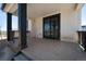 Covered back porch with dark posts and a sliding glass door at 1041 W Witherspoon Dr, Elizabeth, CO 80107