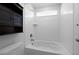 Bright white bathroom with a tiled shower-tub, vanity and a storage cabinet at 1041 W Witherspoon Dr, Elizabeth, CO 80107