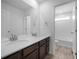 Bathroom featuring double sinks and vanity with an adjoining toilet and shower area at 1041 W Witherspoon Dr, Elizabeth, CO 80107