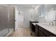 Bright bathroom features double sinks, white countertops, and a tiled shower at 1041 W Witherspoon Dr, Elizabeth, CO 80107