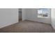 Carpeted bedroom featuring a window and a walk-in closet at 1041 W Witherspoon Dr, Elizabeth, CO 80107