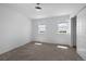 Bright bedroom features neutral carpet, two windows, fresh white walls, and sliding door closet at 1041 W Witherspoon Dr, Elizabeth, CO 80107