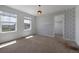 Bedroom with carpet, wallpapered wall, two windows and walk in closet at 1041 W Witherspoon Dr, Elizabeth, CO 80107