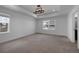 Large bedroom features neutral carpet and a tray ceiling with modern chandelier at 1041 W Witherspoon Dr, Elizabeth, CO 80107
