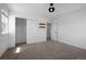 Bright bedroom featuring neutral carpet, fresh white walls, an open closet, and a modern ceiling light at 1041 W Witherspoon Dr, Elizabeth, CO 80107