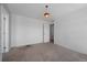 Bedroom featuring neutral carpet, a modern light fixture, and white walls at 1041 W Witherspoon Dr, Elizabeth, CO 80107