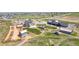 Aerial view of community garden, surrounded by greenery and charming structures at 1041 W Witherspoon Dr, Elizabeth, CO 80107