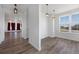 Bright dining room with hardwood floors, modern pendant lights, and a large window with a view at 1041 W Witherspoon Dr, Elizabeth, CO 80107