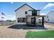 Charming two-story modern farmhouse featuring white siding, black trim, and a covered front porch at 1041 W Witherspoon Dr, Elizabeth, CO 80107