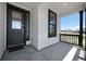 View of front porch with black railings, a storm door and a window with black trim at 1041 W Witherspoon Dr, Elizabeth, CO 80107