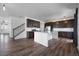 Open kitchen with dark cabinets, white countertops and island, and stainless steel appliances at 1041 W Witherspoon Dr, Elizabeth, CO 80107