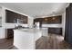Modern kitchen with stainless steel appliances, a center island, and dark wood cabinetry at 1041 W Witherspoon Dr, Elizabeth, CO 80107