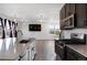 Modern kitchen featuring stainless steel appliances, white countertops, and an open floor plan at 1041 W Witherspoon Dr, Elizabeth, CO 80107
