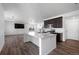Open kitchen with a center island, stainless steel appliances, and seamless flow to the living area at 1041 W Witherspoon Dr, Elizabeth, CO 80107
