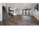 Expansive living room boasts hardwood flooring, recessed lights, and abundant natural light from large windows at 1041 W Witherspoon Dr, Elizabeth, CO 80107