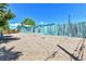 Spacious backyard with blue house and gravel area at 1500 S Wolcott Ct, Denver, CO 80219