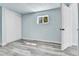 Bedroom with light grey wood-look floors, closet, and door at 1500 S Wolcott Ct, Denver, CO 80219