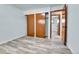 Bedroom with ample closet space, neutral walls, and gray wood floors at 1500 S Wolcott Ct, Denver, CO 80219
