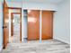 Bedroom with ample closet space, neutral walls, and gray wood floors at 1500 S Wolcott Ct, Denver, CO 80219