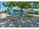 Charming turquoise home with well-maintained landscaping, sidewalk, and blue fence at 1500 S Wolcott Ct, Denver, CO 80219