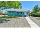 Charming blue single-story home with manicured lawn, rock landscaping, and a bright and welcoming exterior at 1500 S Wolcott Ct, Denver, CO 80219