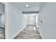 Hallway with light grey wood-look floors at 1500 S Wolcott Ct, Denver, CO 80219