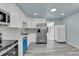 Bright kitchen featuring white cabinets, stainless steel appliances and modern countertops at 1500 S Wolcott Ct, Denver, CO 80219
