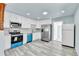Bright kitchen featuring white cabinets, stainless steel appliances and modern countertops at 1500 S Wolcott Ct, Denver, CO 80219
