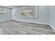 Bright room featuring gray wood floors, ample natural light, and neutral decor at 1500 S Wolcott Ct, Denver, CO 80219