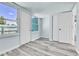 Sunroom with windows and light wood-look floors at 1500 S Wolcott Ct, Denver, CO 80219