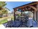Backyard featuring a shaded stone patio, outdoor seating, lush green lawn and mature trees at 4969 Thorndike Ave, Castle Rock, CO 80104