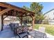 Outdoor living space with covered patio, ceiling fan, and stylish furniture for relaxing and entertaining at 4969 Thorndike Ave, Castle Rock, CO 80104