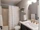 Bathroom featuring a shower-tub combo with white tiles and marble countertop vanity at 4969 Thorndike Ave, Castle Rock, CO 80104