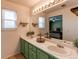 Bathroom featuring double sinks and a view to the bedroom via the mirror at 4969 Thorndike Ave, Castle Rock, CO 80104
