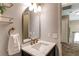 Bathroom features a vanity with marble countertop and a decorative arched mirror at 4969 Thorndike Ave, Castle Rock, CO 80104
